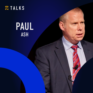 Portrait of Paul Ash in a dark blue background with a blue circle and logo of 20 Talks on the left side.