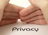 Hands protecting the word PRIVACY