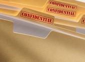 Folders with a stamp saying CONFIDENTIAL